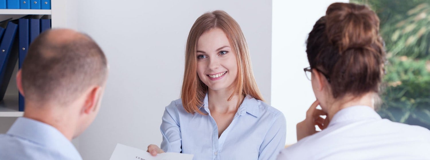 Interview techniques - Young Professional Woman presenting CV to interviewers